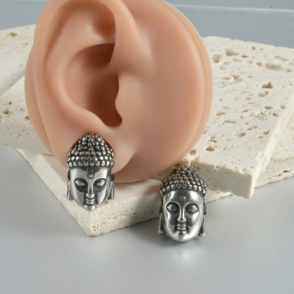 Stainless steel geometric earrings with hollow skull and Buddha head design in gold, black, steel, or Buddha head finish.