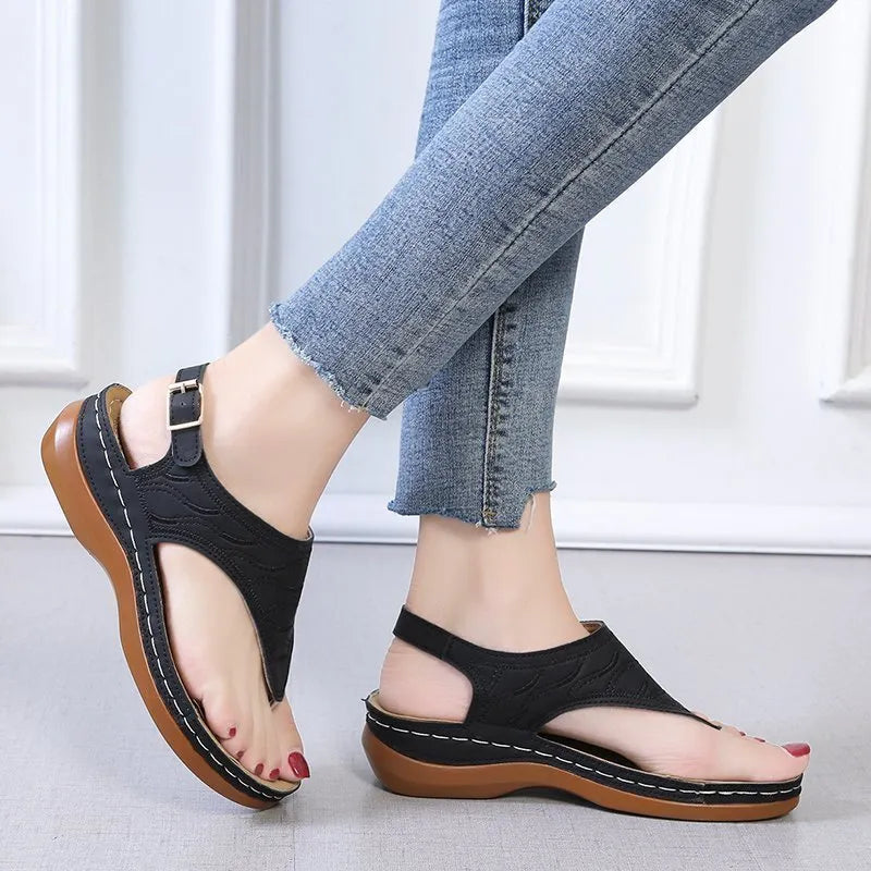 Women's casual wedge heel flip flop sandals with an adjustable buckle strap in a solid colour.