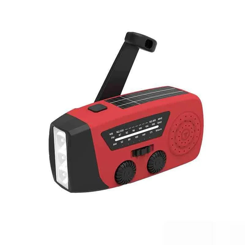 Red rechargeable emergency hand-crank radio with LED torch and USB port for disaster prevention