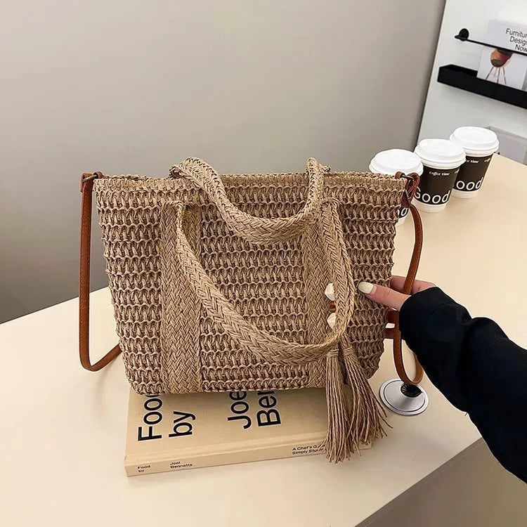 Large straw crossbody bag with woven raffia construction and polyester lining