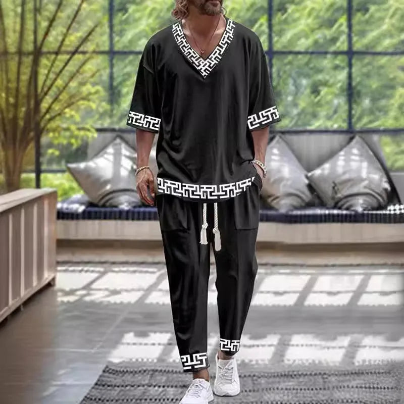 Women's light grey V-neck cropped sleeve jacket and matching trousers suit set on a hanger.