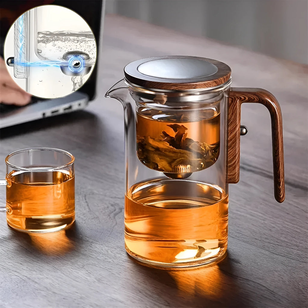 Glass teapot with wooden handle showing magnetic separation mechanism for loose leaf tea brewing
