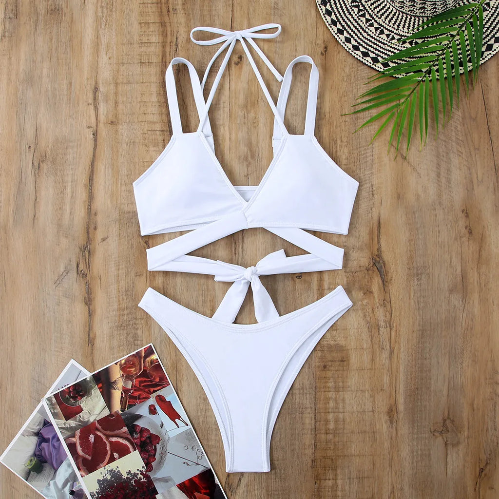 Women's solid colour bikini swimsuit with adjustable straps on a hanger, shown in red.