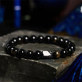 Single strand bracelet with 8mm round beads in natural obsidian, malachite or tiger eye stones.