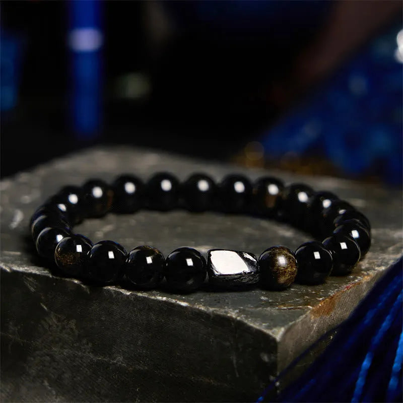 Single strand bracelet with 8mm round beads in natural obsidian, malachite or tiger eye stones.