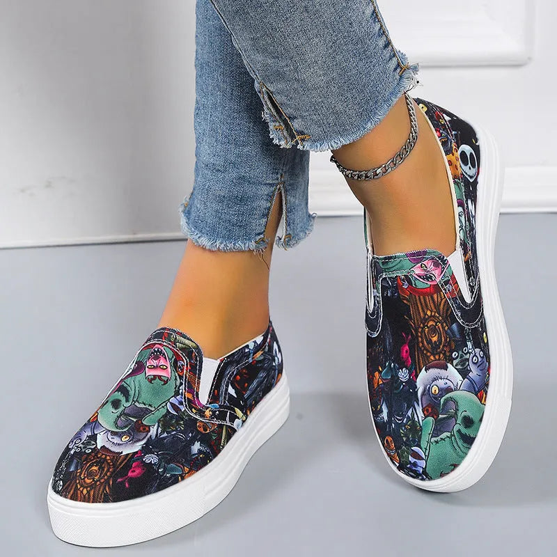 Women's low-top canvas trainers in blue, green, black and colourful patterns with a flat rubber sole.