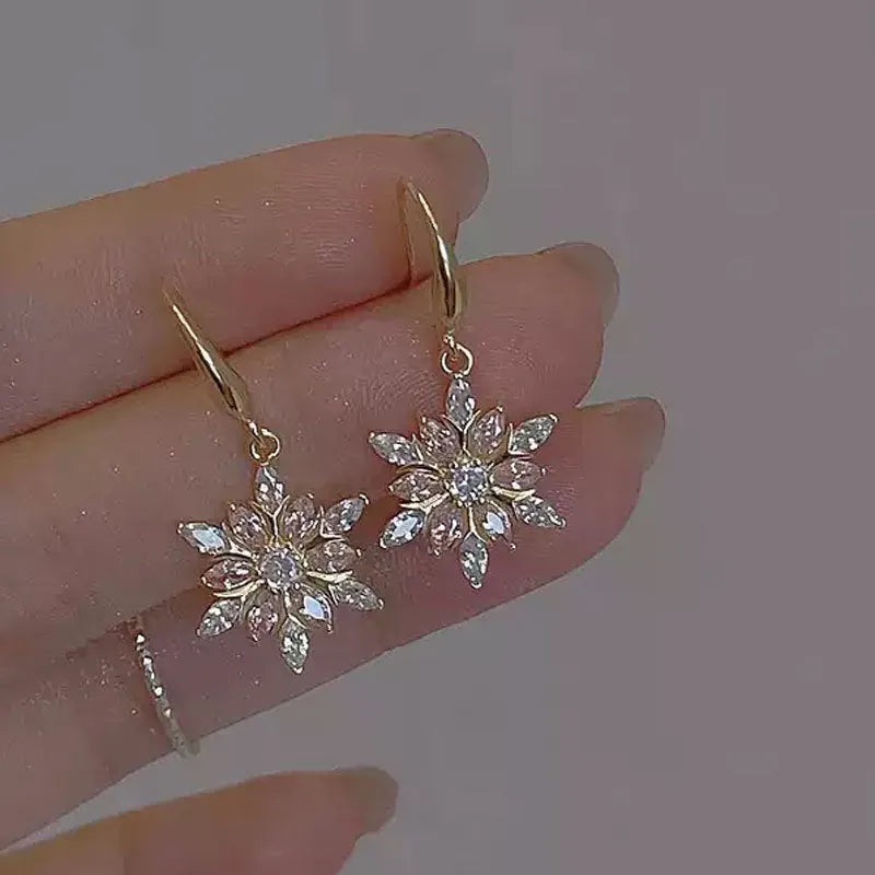 Gold snowflake earrings with zircon stones on alloy base, geometric design for women