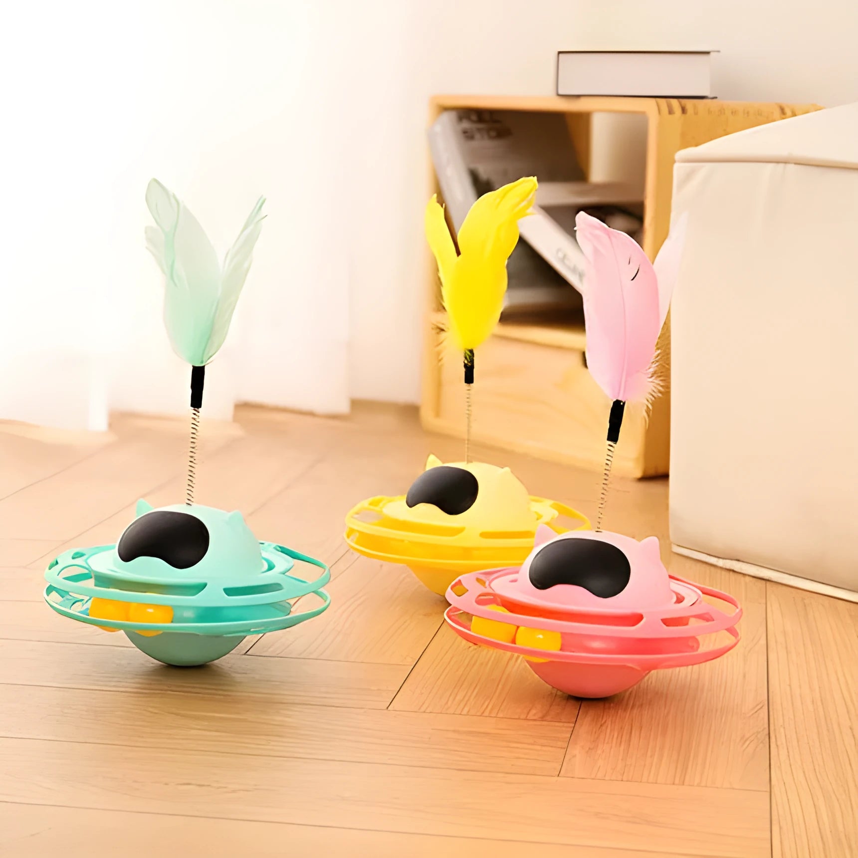 Pink cat tumbler turntable toy with interactive play stick on a flat surface.