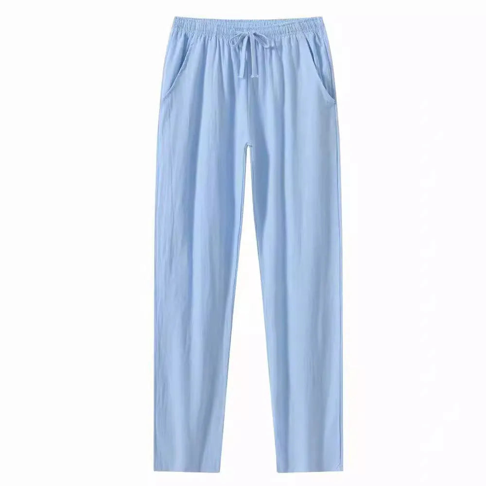 Men's loose-fitting cotton linen casual trousers in khaki colour on a neutral background.