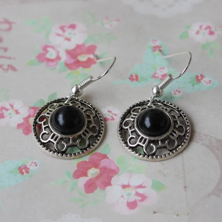 Handmade geometric flower disk earrings made of Tibetan silver and turquoise with ethnic patterns.