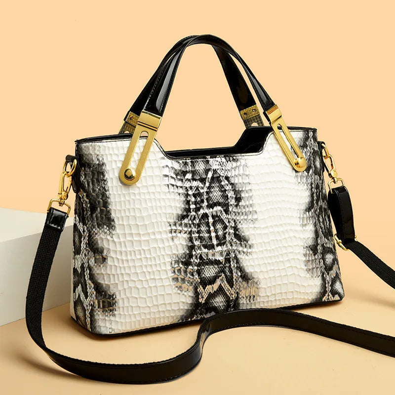 Black retro style shoulder messenger bag with chain detailing and horizontal square silhouette