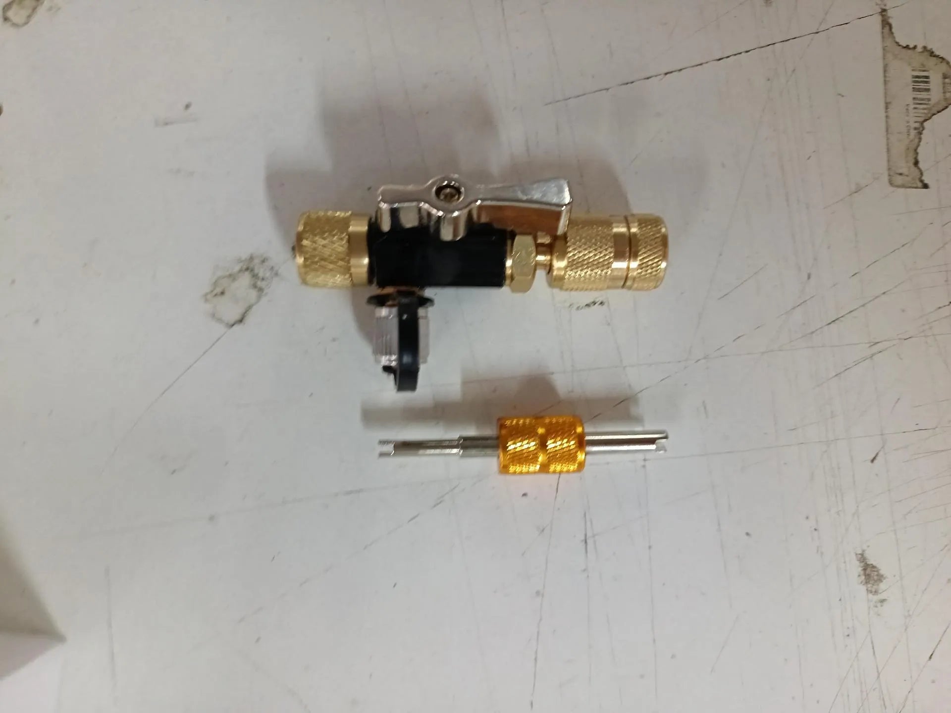 Vacuum valve core disassembly tool set showing metal valve removers in 1/4 inch and 5/16 inch sizes with four style configuration options