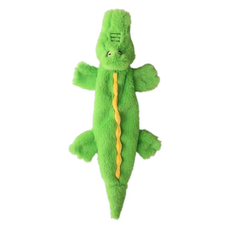 Green crocodile plush dog toy with no stuffing, showing squeaker in head and crinkle paper tail