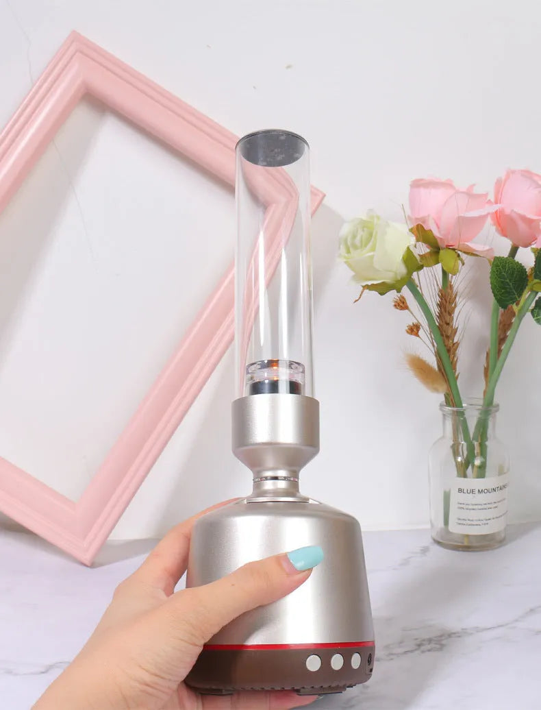 White silver modern candlelight Bluetooth speaker and night light on a surface, showing its upright 90x277mm design.