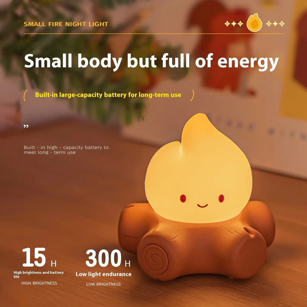 Small yellow silicone night lamp with cartoon fire pile design on a table.