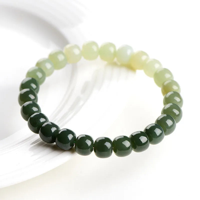 Hetian Jade bracelet with water gradient colours showing polished beads in natural stone