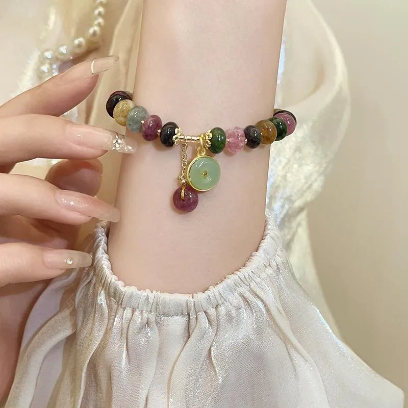 Handmade colourful tourmaline abacus bracelet with rabbit pendant charm on wrist