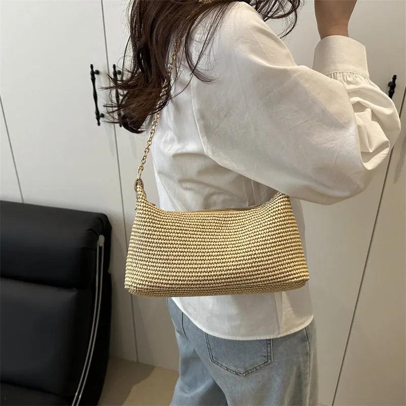 Woven straw crossbody handbag with square shape in khaki colour showing phone pocket