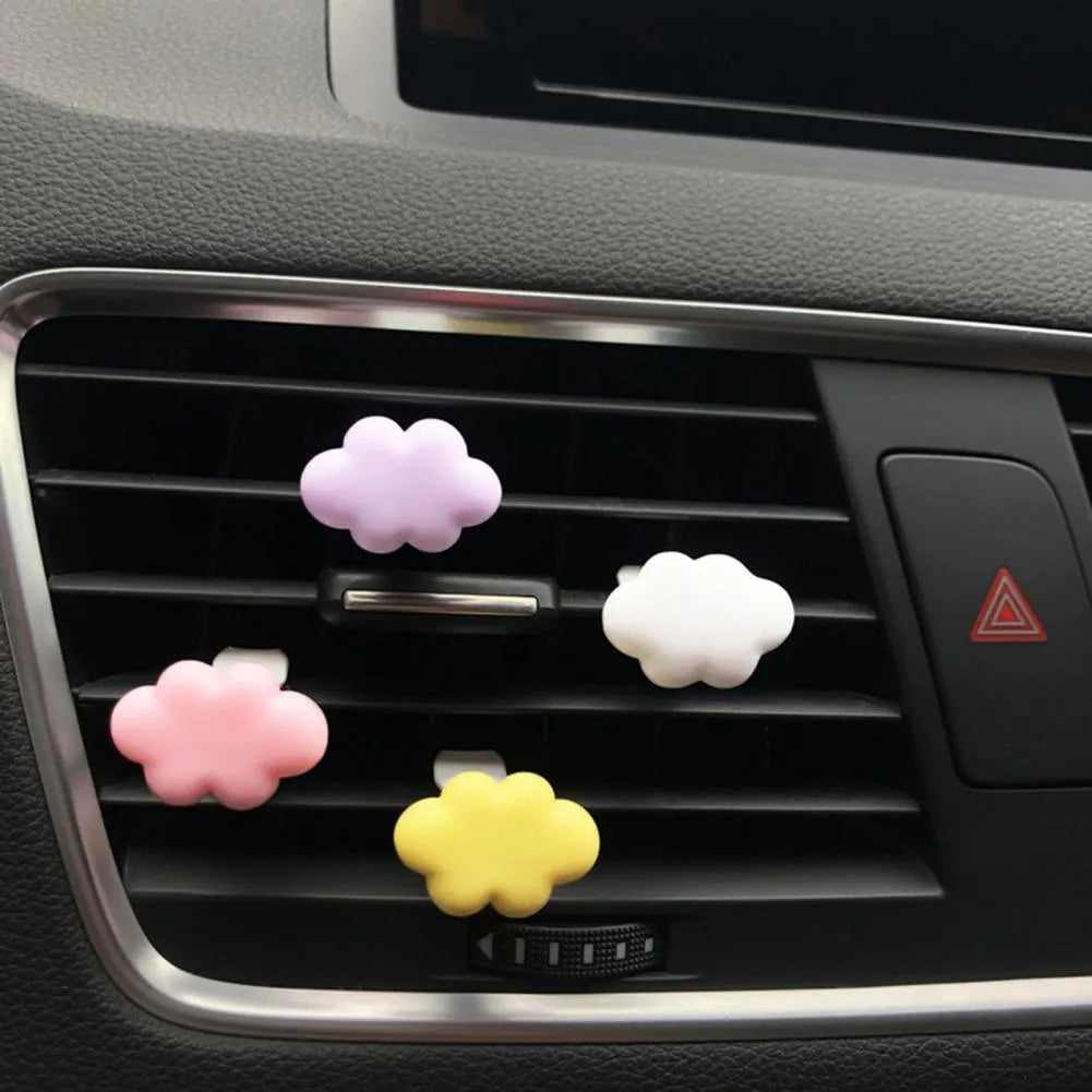 Resin cartoon cloud car fragrance clip in pastel colours mounted on vehicle air vent
