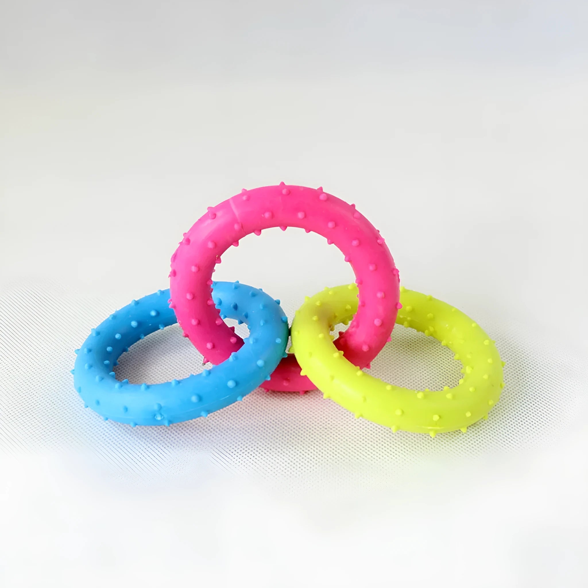 TPR rubber three-chain link dog molar chew toy for large breed dogs on a white background.