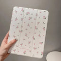 Transparent floral patterned iPad case with tri-fold magnetic stand open