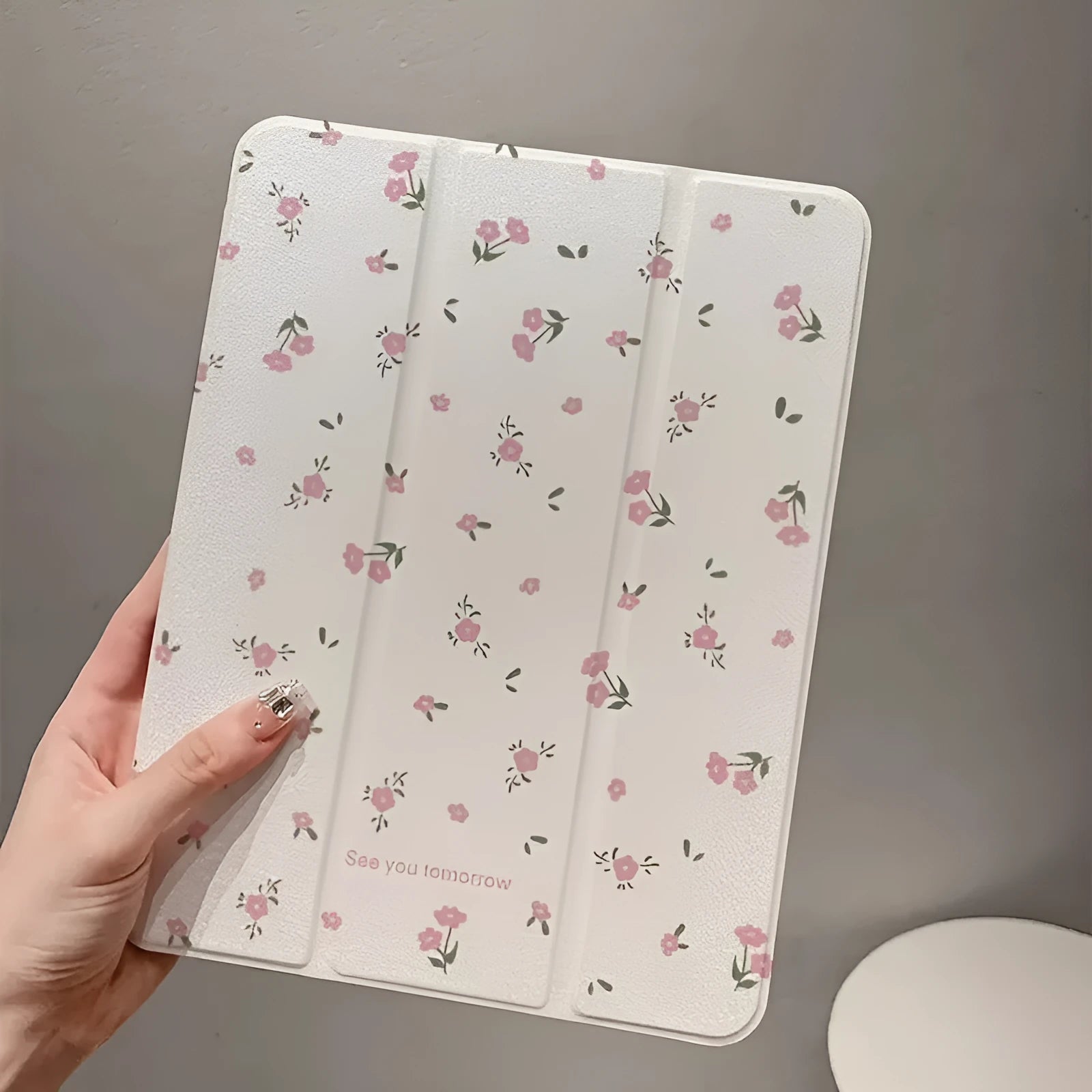 Transparent floral patterned iPad case with tri-fold magnetic stand open