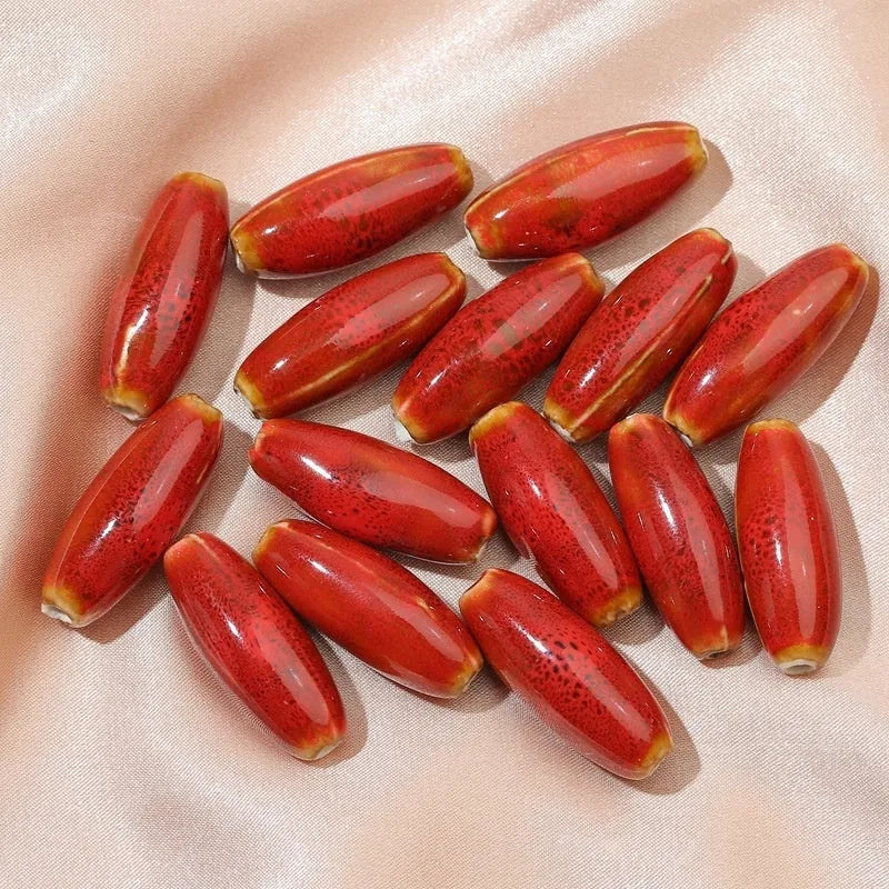Assortment of ceramic bullet beads in flower glaze colours for jewellery making