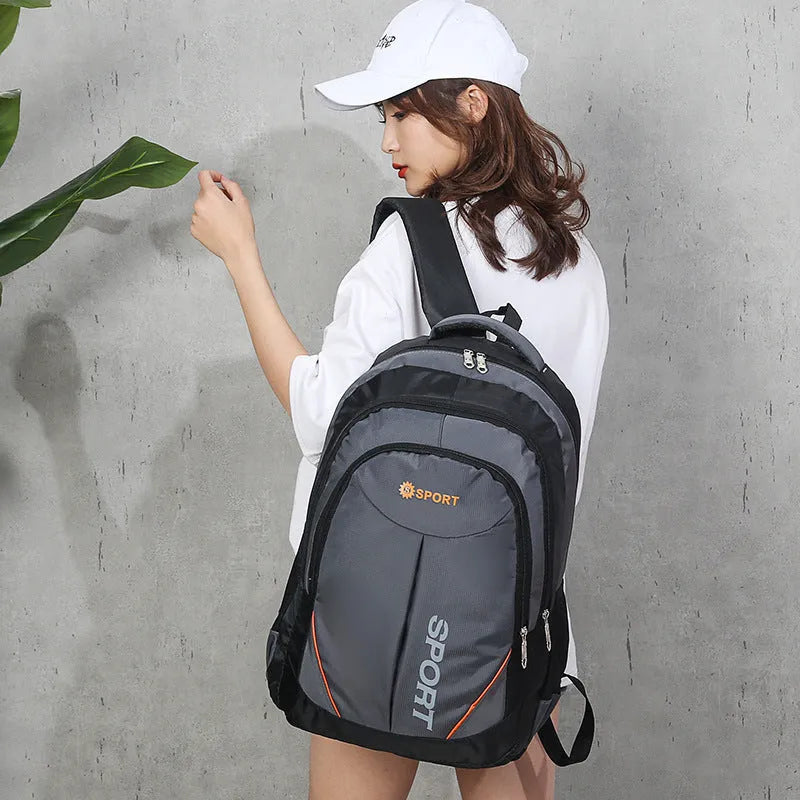 Men's large capacity nylon backpack in grey colour with curved shoulder straps and letter detailing