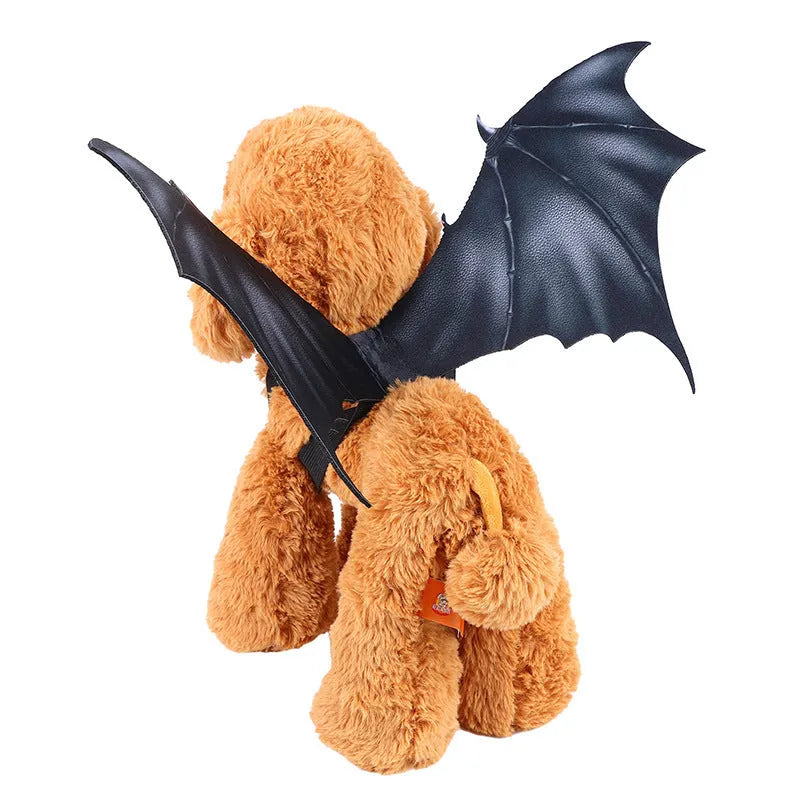 Black cloth bat wing costume accessory for a dog or cat on a Halloween background.