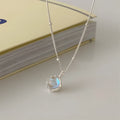 Silver necklace with geometric stone pendant on an adjustable curb chain.