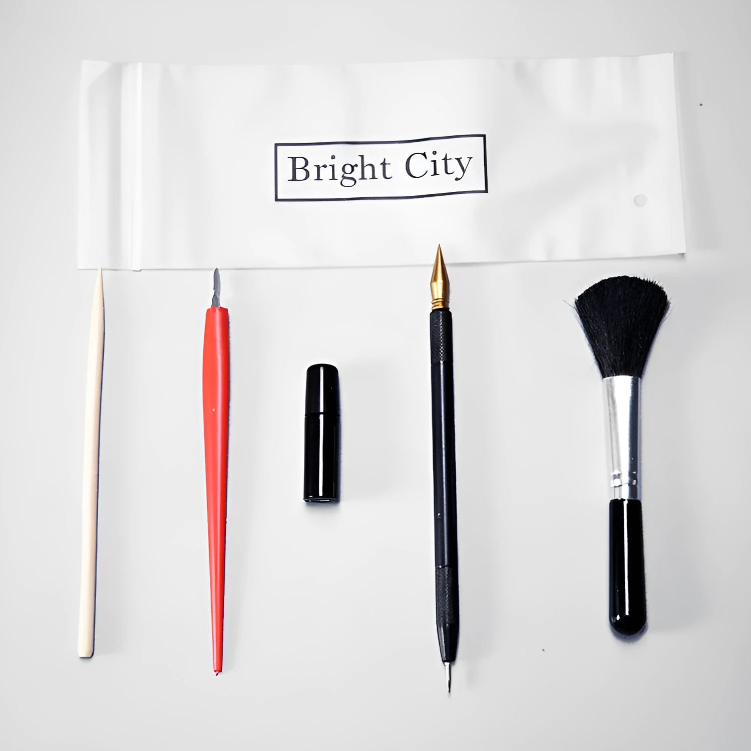 Scraping painting tools set with multiple art tools on white card surface