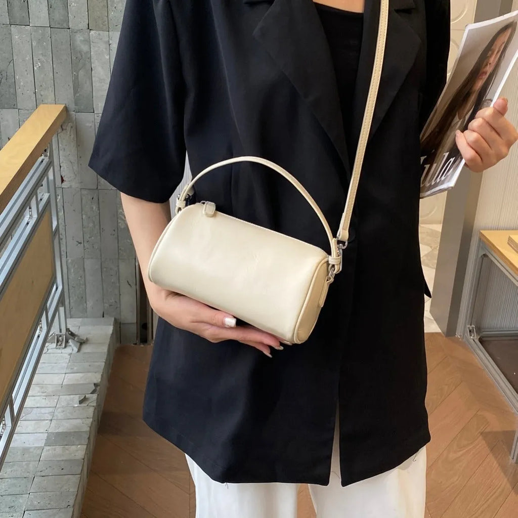 Cylindrical genuine leather crossbody bag in dark brown with contrast stitching