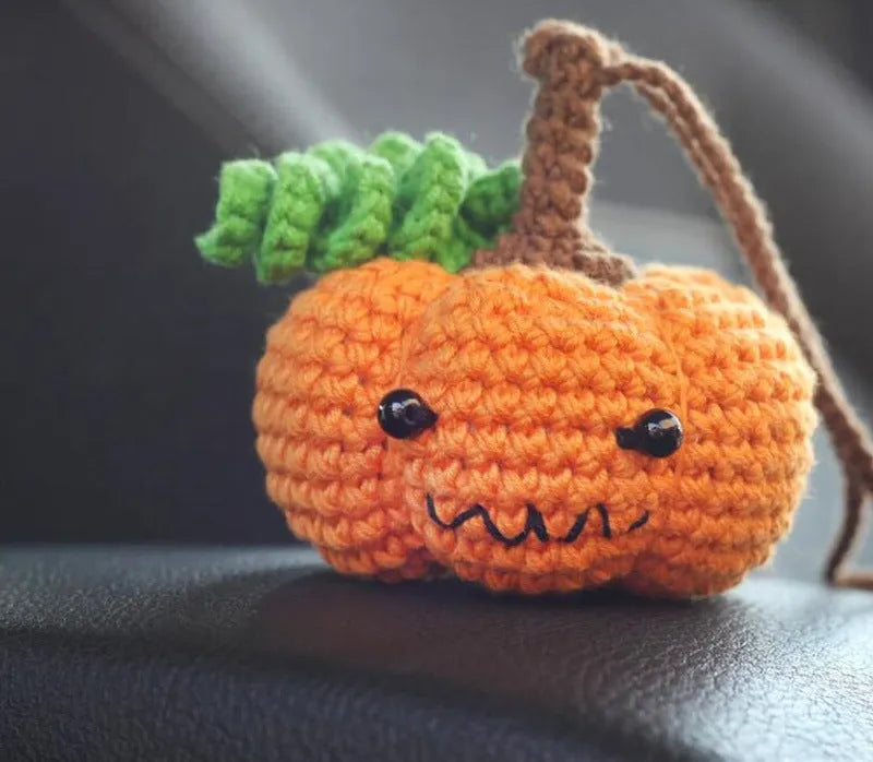 Plush hand-woven car hanging ornament with a selection of cartoon designs like ghosts and pumpkins.