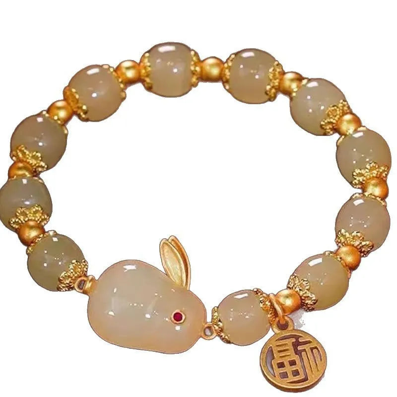 Handcrafted glass peace buckle bracelet with coloured glaze rabbit design on a white background.