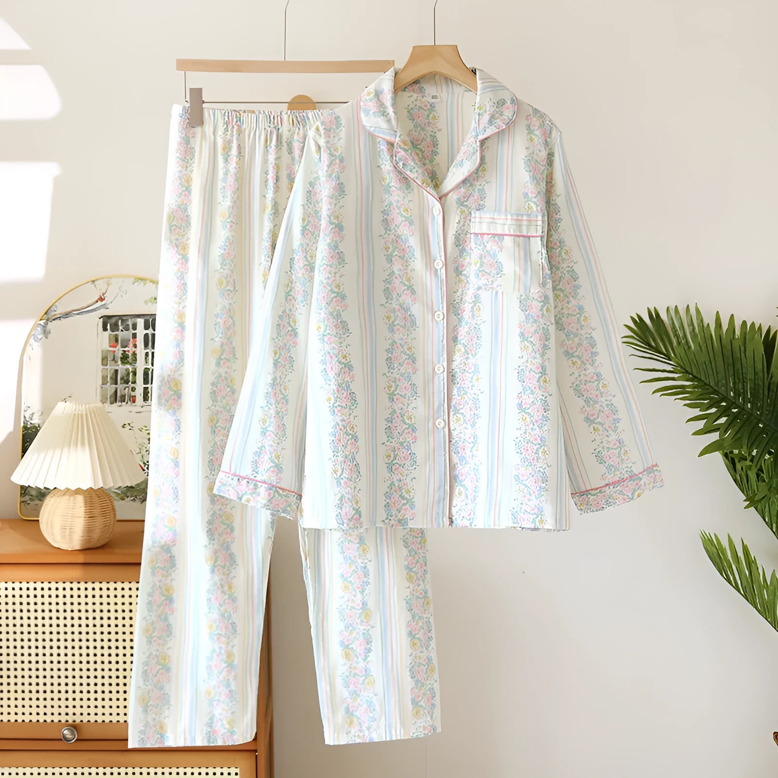 Women's cotton gauze pyjama set with long sleeves and trousers in stripe and red fruit patterns.