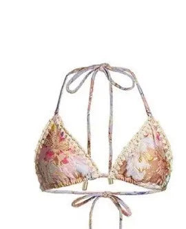Women's beige floral bikini set with matching skirt on neutral background