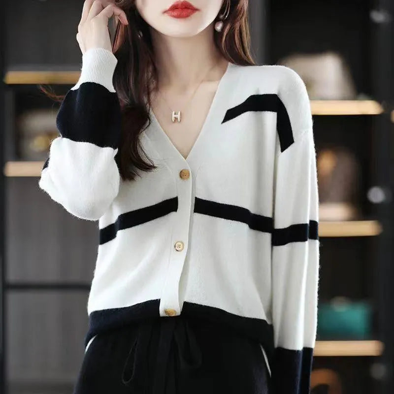 Women's striped V-neck knitted cardigan buttoned up, showcasing its slim fit and 3D pattern texture.