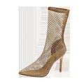 Gold high heel sandals with mesh upper and pointed stiletto design on rubber sole