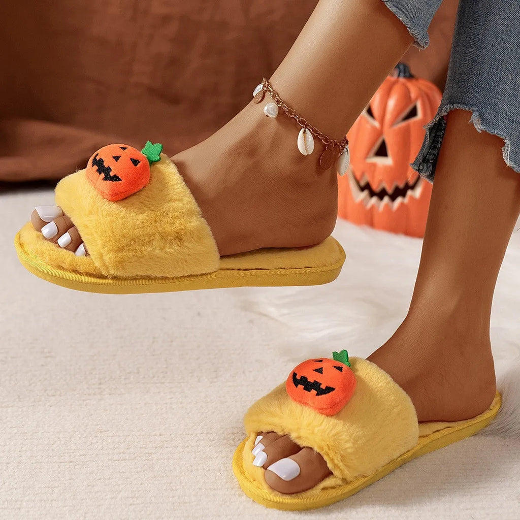 Yellow Halloween pumpkin cartoon design plush slippers with synthetic fur and a light-coloured sole.