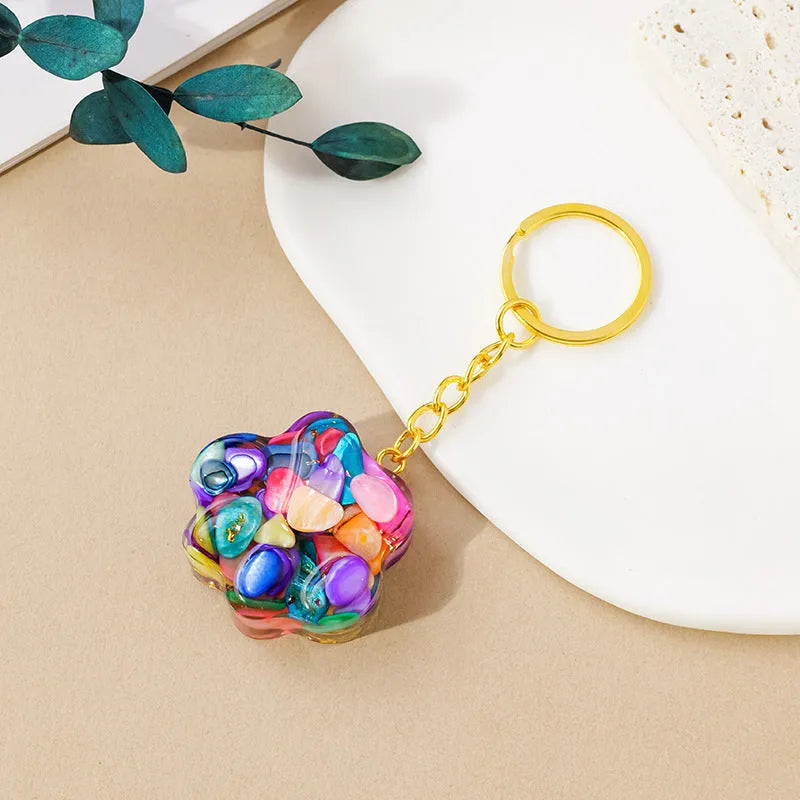 Natural crystal cat's paw keychain pendant on a keyring, colour varies by random gemstone type.
