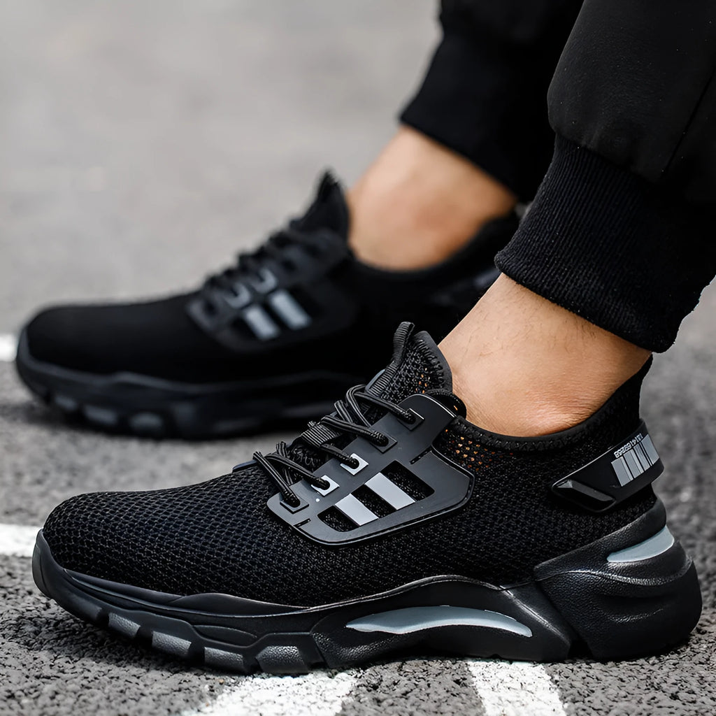 Men's black low-top safety work shoes with Flyknit upper and steel toe cap on a white background