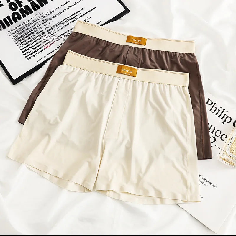 Pack of three men's solid colour ice silk boxer shorts laid flat.