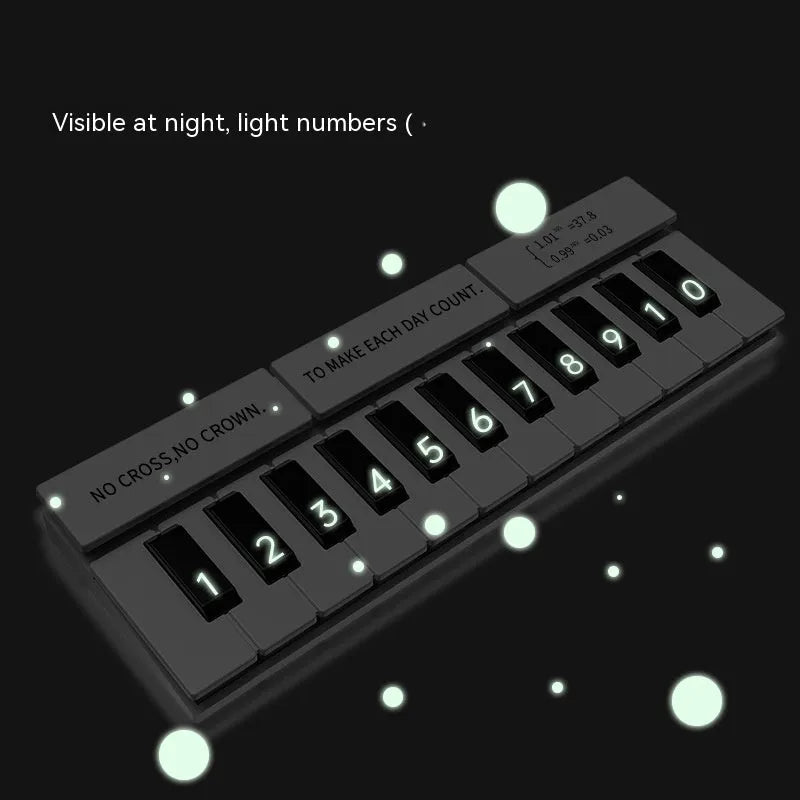 Black and white plastic piano-shaped temporary parking sign for car dashboard.