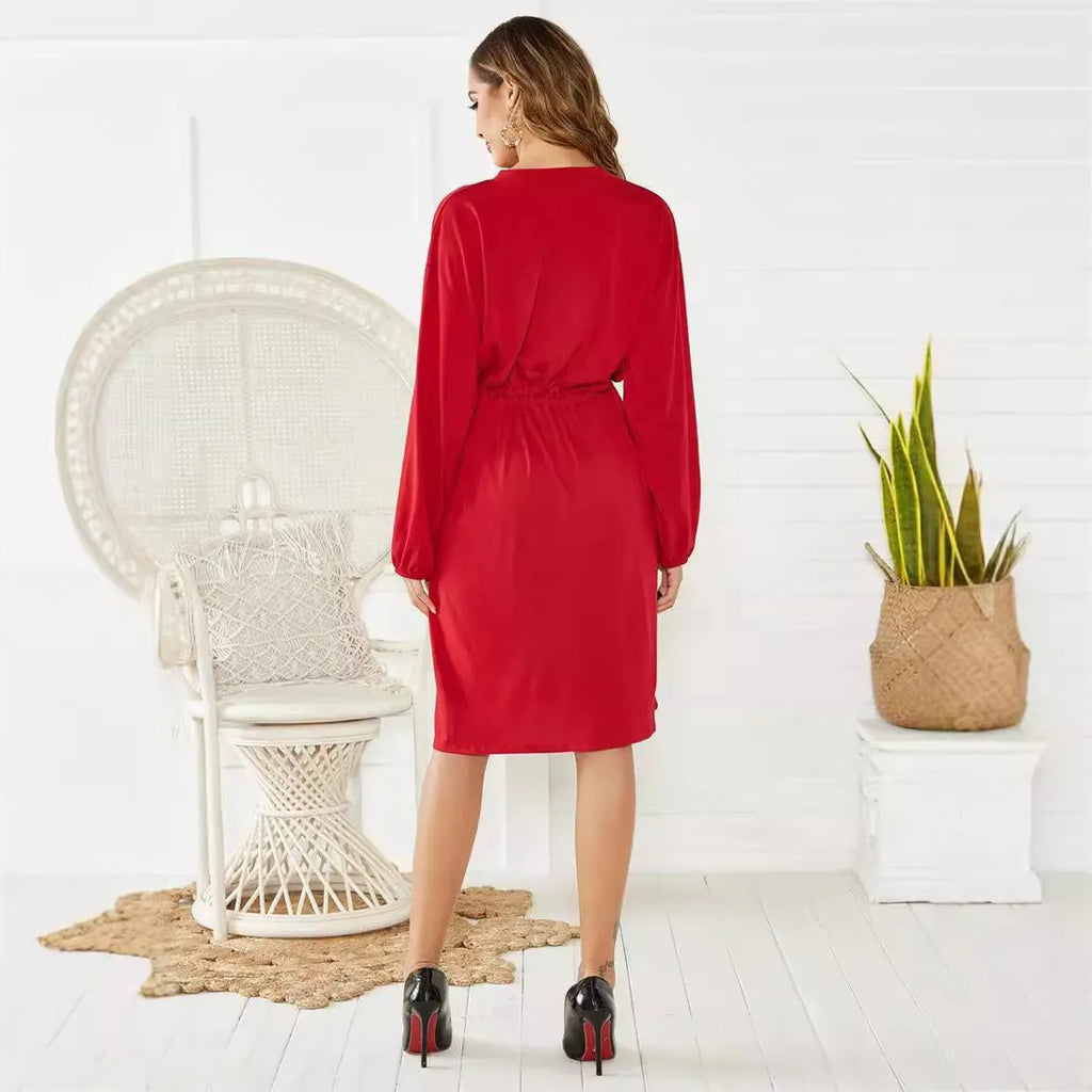 Women's black A-line dress with long sleeves, elastic waist, and a cinching belt.