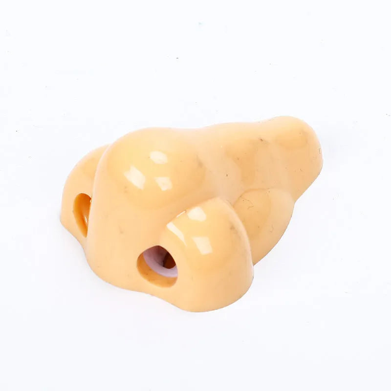 Flesh colour plastic pencil sharpener with large nostril design measuring 58x45x30mm