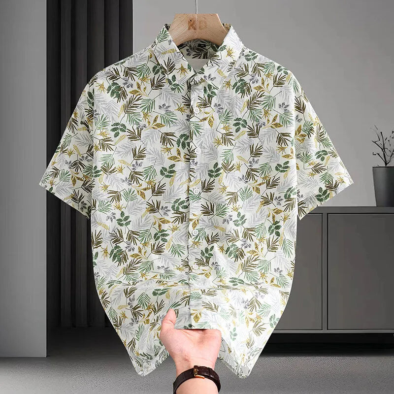 Man wearing a short sleeve Hawaiian style casual shirt with a floral printed pattern.