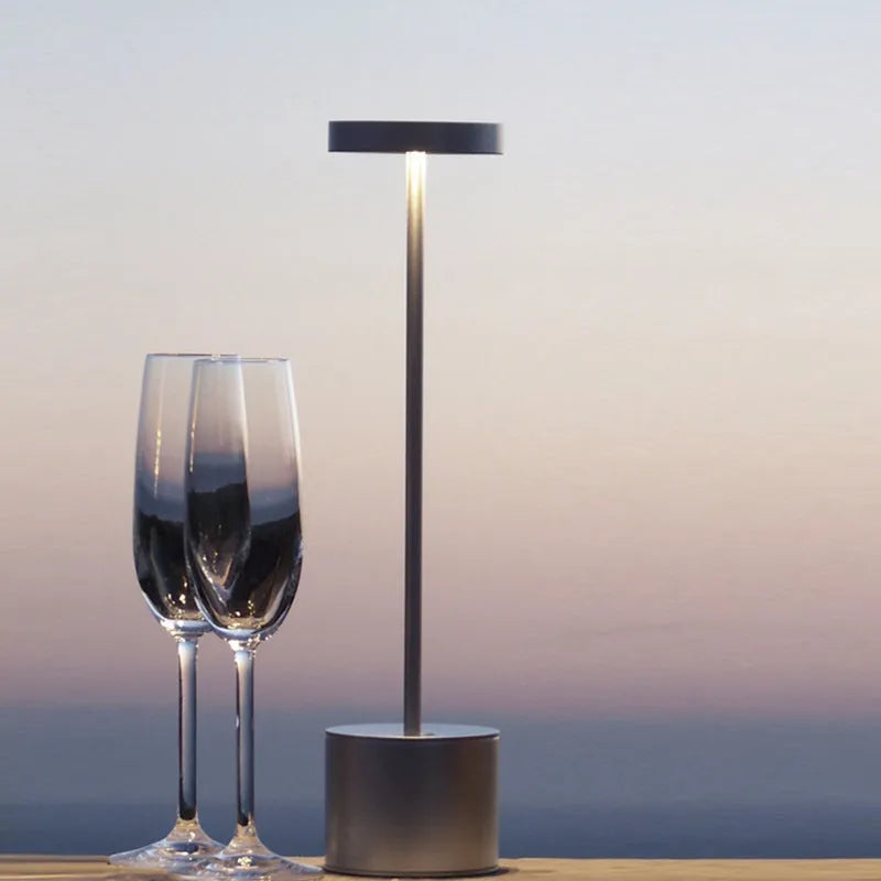 All-aluminium rechargeable LED touch desk lamp in black finish on a wooden desk