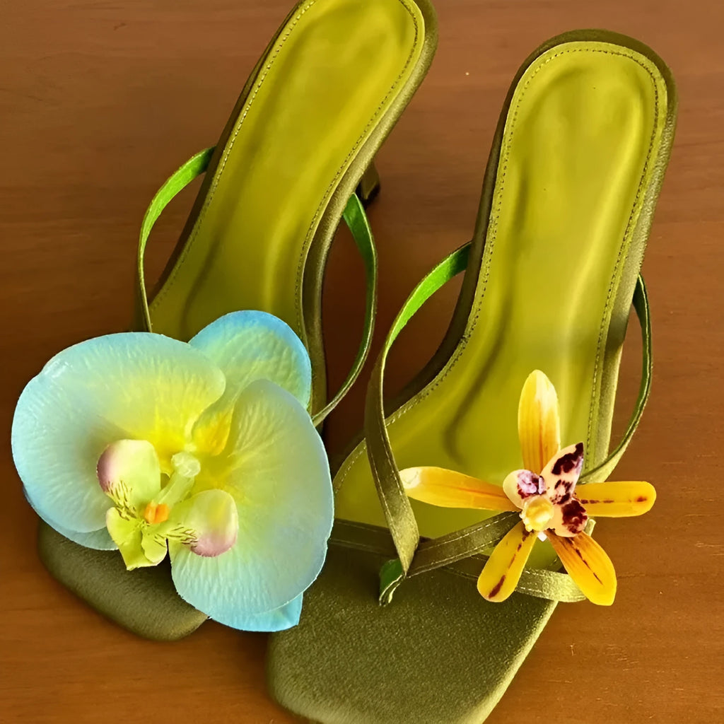 Women's handmade asymmetric floral high heel sandal in calf leather on a white background.