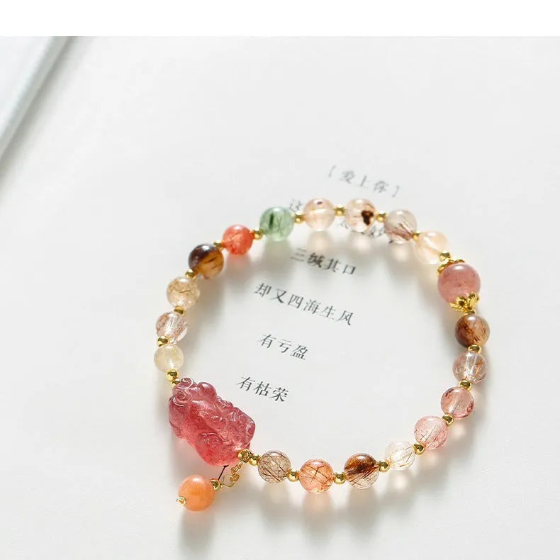 Women's strawberry quartz crystal bracelet with copper construction and pearl detailing in Chinese style design.