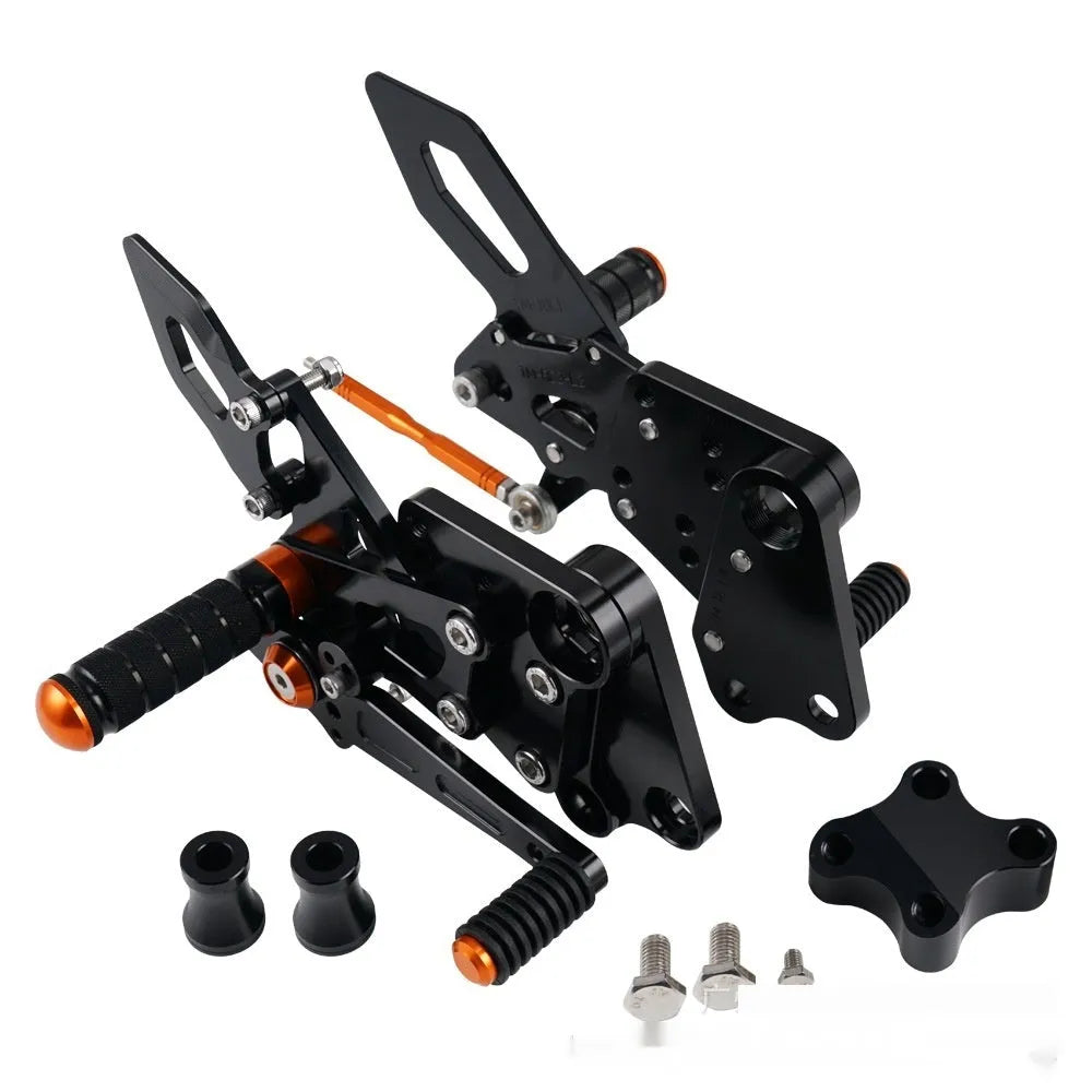 Black and orange KTM Duke motorcycle pedal support bracket assembly